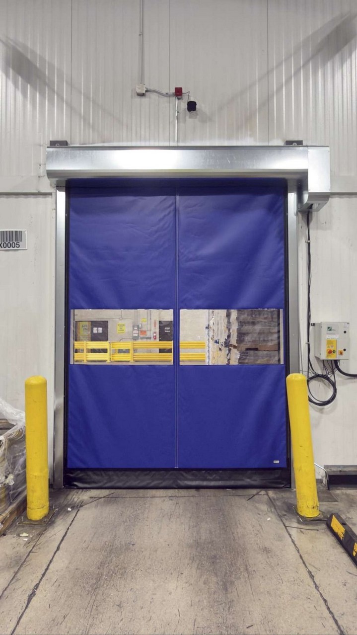 New blue high-speed fabric door with vision panels installed at a Sylmar cold storage doorway by InSev Tech