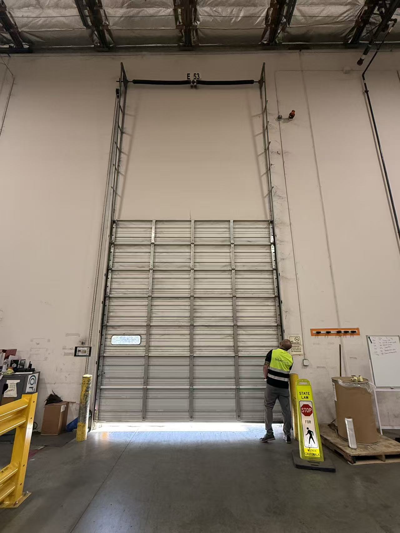 Door E53: high-bay dock door under inspection.