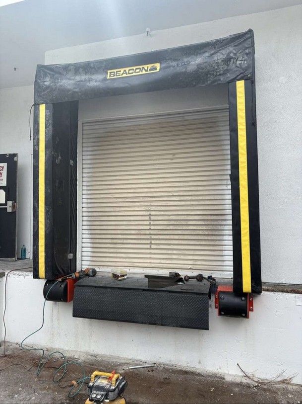 Dock shelter head curtain installed above a new edge-of-dock leveler