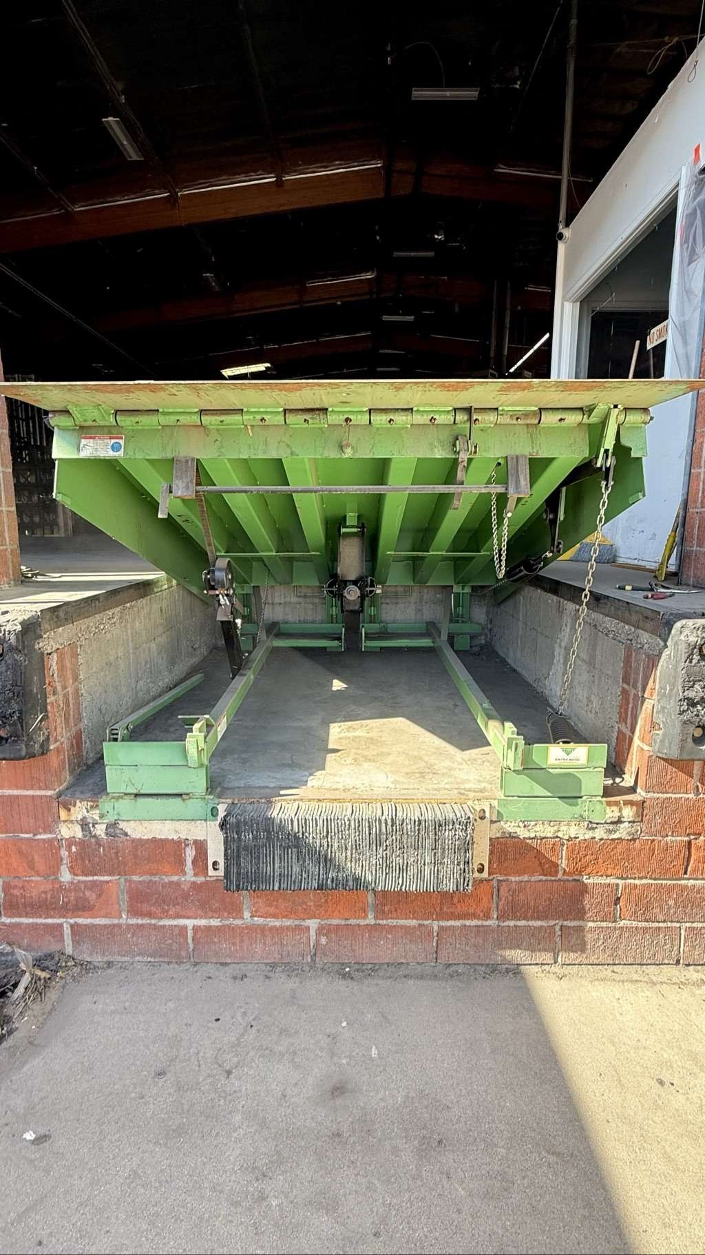Raised Kelley mechanical dock leveler after hold down assembly replacement in Sun Valley