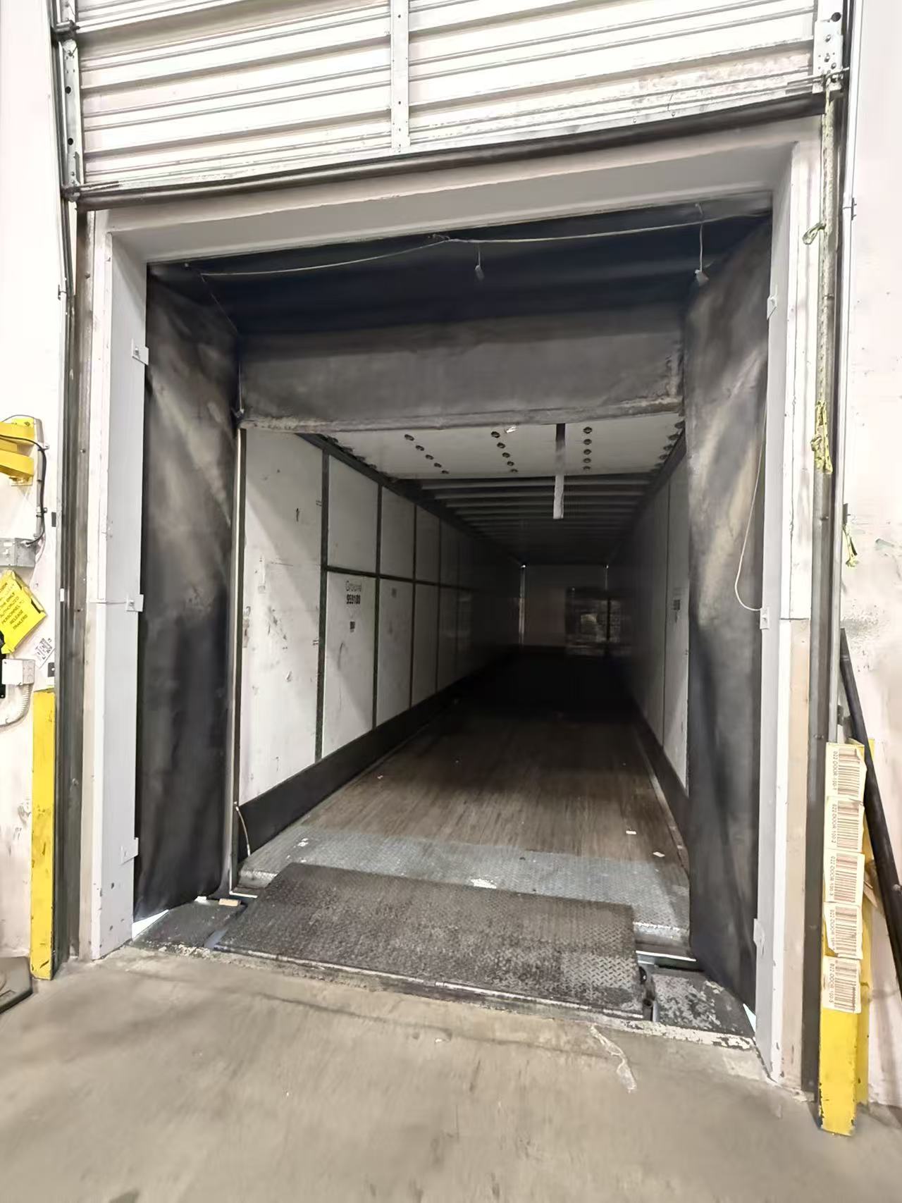 Dock shelter and curtain at a trailer position, showing wear that can affect sealing.