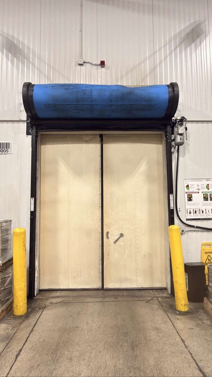 Worn high-speed roll-up door at a Sylmar cold storage room before replacement