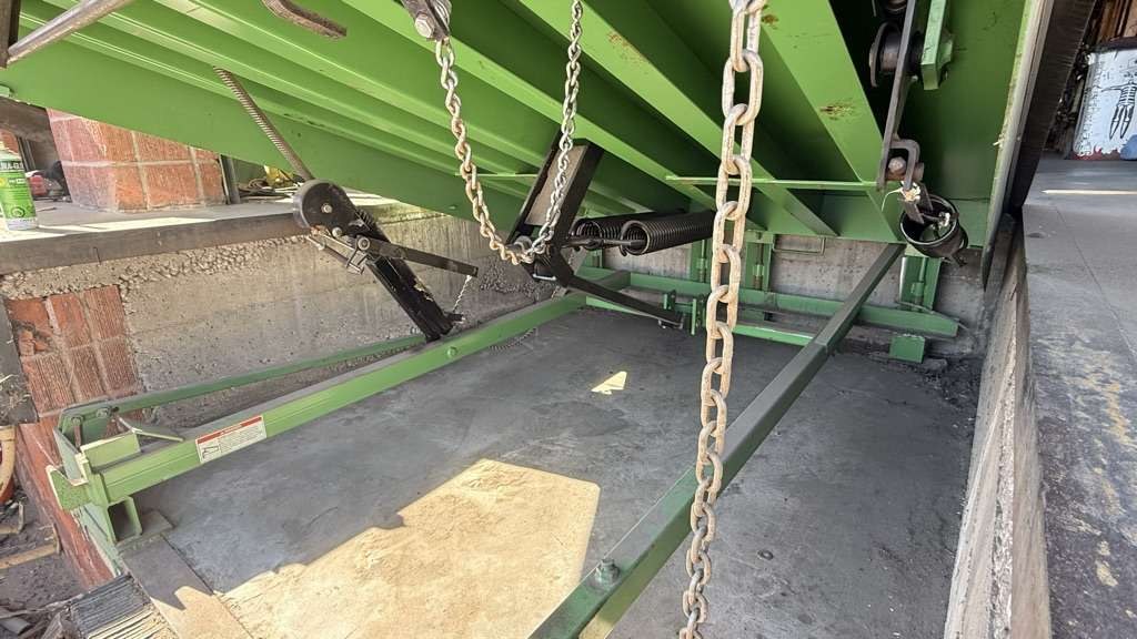 New hold down assembly and adjusted pull chains beneath a Kelley mechanical dock leveler