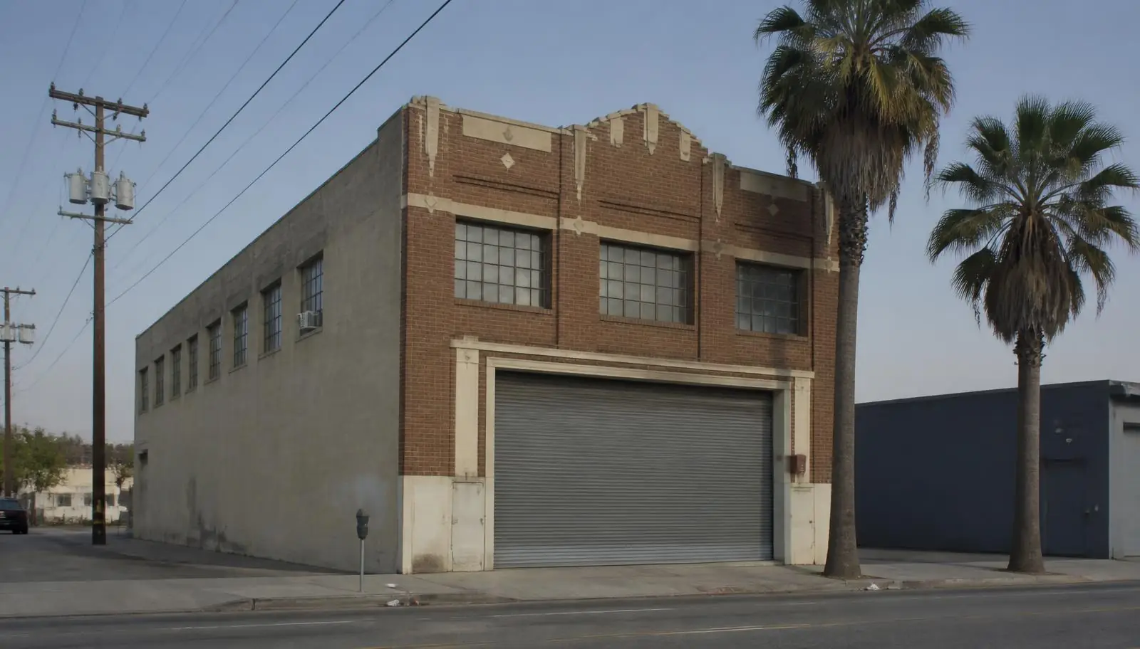 Older commercial building with a street-level rolling steel door in Glendale CA