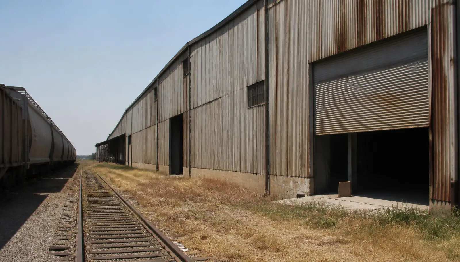 Rail-served manufacturing plant with wide rolling steel doors in Pomona CA