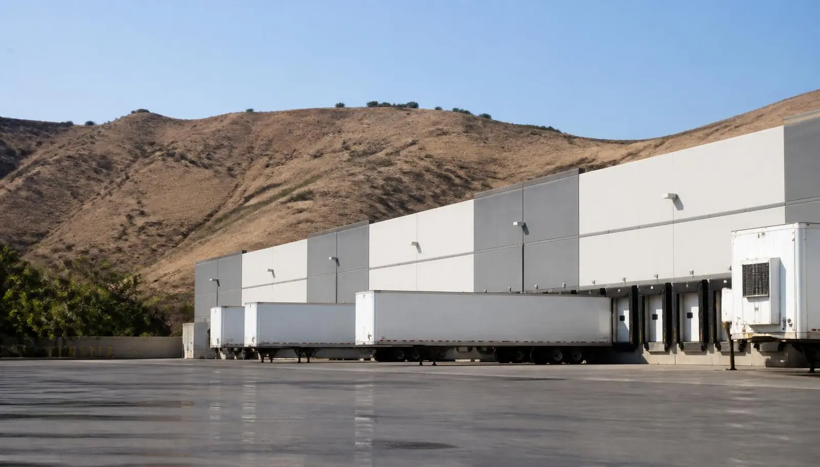 Inland distribution warehouse dock bank with trailers in Riverside CA
